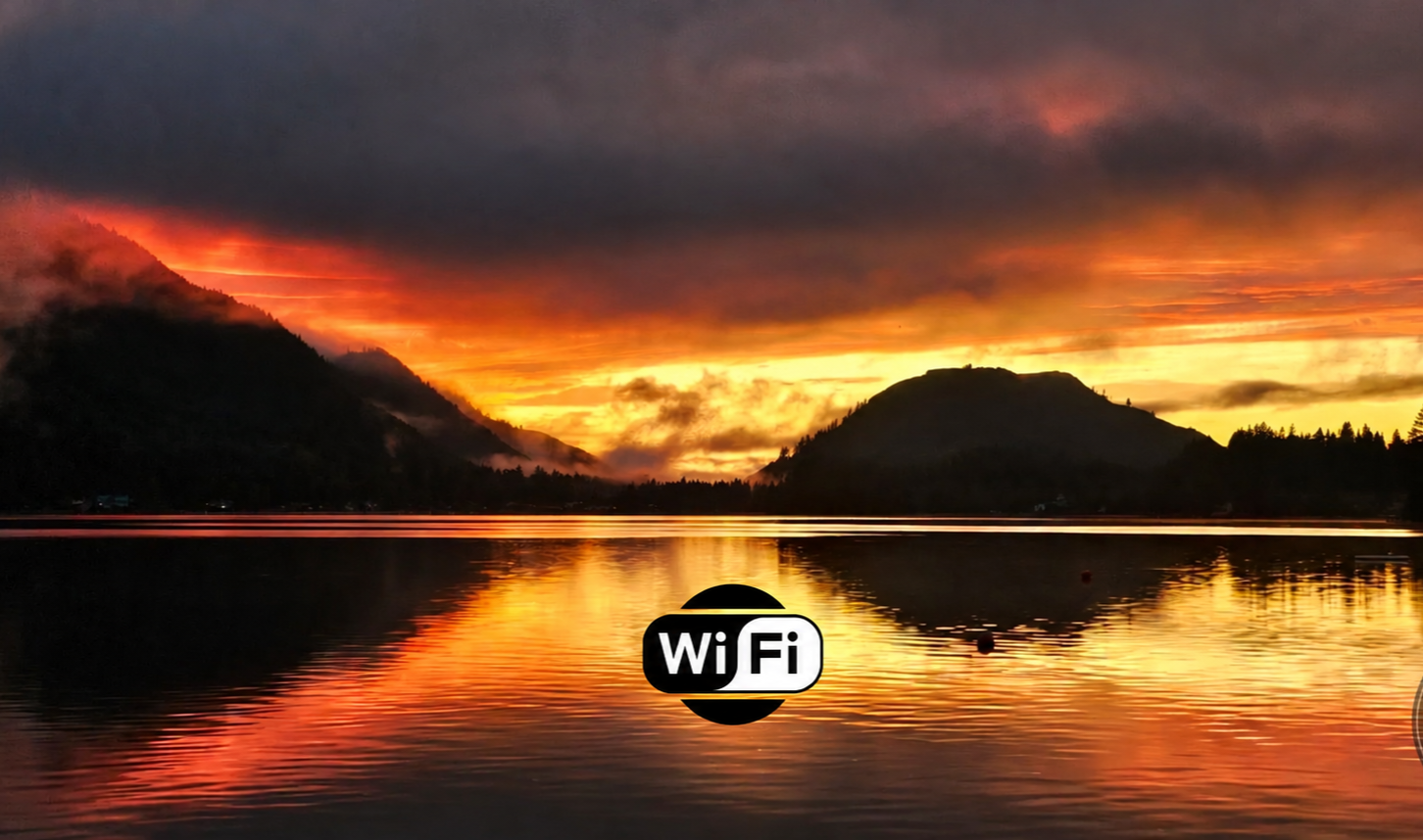 Fiery sunset over Lake Cavanaugh reflected in the water, with a WiFi emblem over the lake