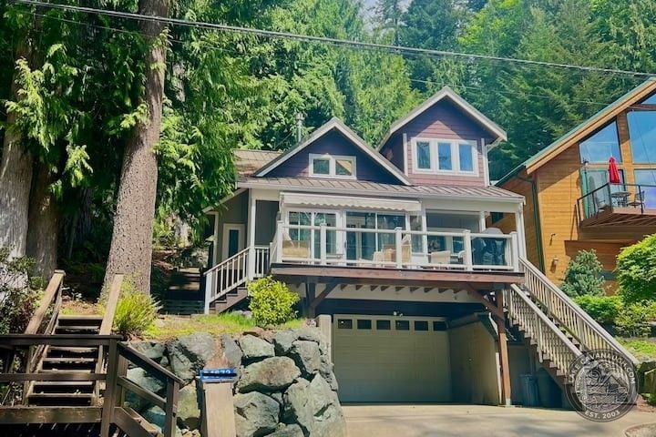 Craftsman Lakefront Home With Deck Tucked Among Tall Evergreens at Lake Cavanaugh